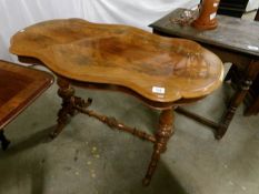 A Victorian mahogany occasional table with flame mahogany veneered top