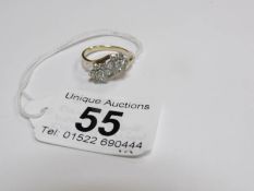 A 9ct gold ring set white stone flower heads,
