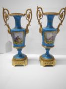 A pair of 19th century continental porcelain and gilt urns