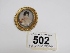 A painted miniature brooch pendant of a young woman with diamonds in her hair,