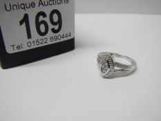 An oval white gold diamond ring, size J