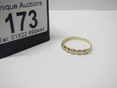A 5 stone line of diamonds yellow gold ring, size T