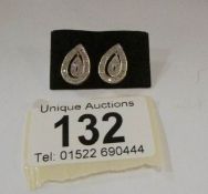 A pair of pear shaped gold and diamond earrings