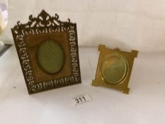 A ornate photo frame and a brass photo frame