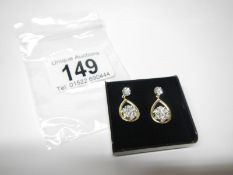 A pair of floral 2 tone gold and diamond earrings