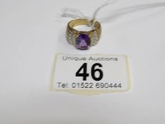 A heavy 9ct gold ring set oval amethyst and pave' shoulder diamonds,