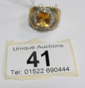 A 9ct gold ring set oval citrine and pave' diamonds,