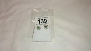 A pair of emerald and diamond yellow gold earrings