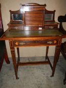 A small rosewood ladies writing desk with tambour front cupboard