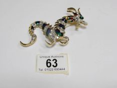 A dragon brooch set coloured stones