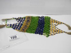 A beaded purse dated 1919 and in suffragette colours?