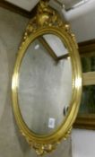 A gilt framed oval mirror