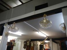 A small and large ceiling light with 2 matching wall lights