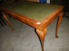 A mahogany writing table with leather inset