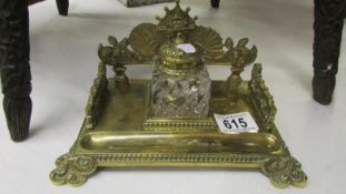 An ornate brass ink stand
