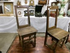 A pair of rustic farm house chairs