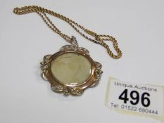 An Edwardian pearl set locket in gold with attached 9ct gold chain