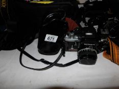 A Nikon AS camera in case with a Nikon Nikkor 50mm 1:18 lens