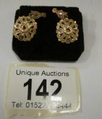 A pair of high carat rose gold and diamond earrings
 
This weighs 3gms