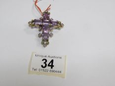 A gold cross set amethyst and peridot