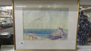 A framed and glazed watercolour of children on beach by Hugo Lischwith