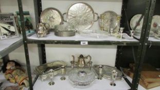A mixed lot of silver plate including trays, hors d'ouvre dishes, goblets etc (2 shelves)