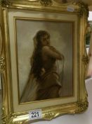 A gilt framed painting of a young woman