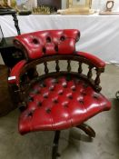 A red leather upholstered desk chair