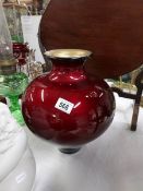 A large red lustre glazed vase