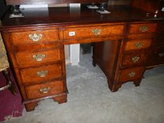 A walnut kneehole desk