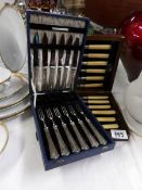 A cased set of 6 fish knives and forks together with a cased set of dessert knives and forks