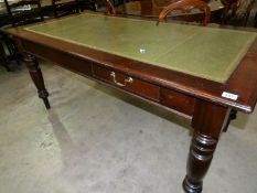 A mahogany writing table with green leather insert