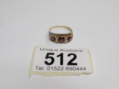 A 9ct rose gold ring set garnets, Birmingham,