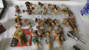 A collection of carved wood character bottle corks
