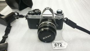 A Nikon FE2 camera in case with Hoya 52mm skylight (IB) lens