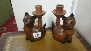 A pair of wooden cat candlesticks