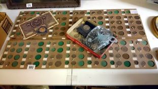 A quantity of coins and coin trays