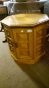 An octagonal centre table with cupboards