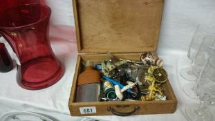 A wooden box of miscellaneous items