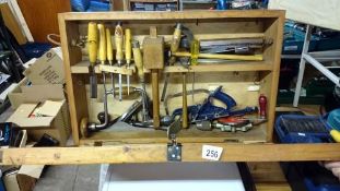 A large wooden tool box and tools