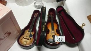 A miniature guitar and violin