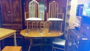 A teak dining table and 5 chairs
