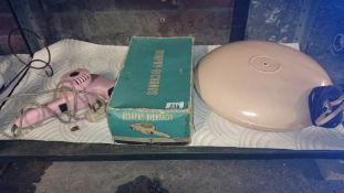 A vintage hair dryer and bed warmer