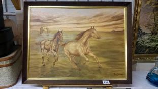 A framed oil on board of horses
