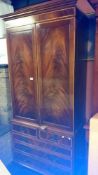 A Victorian mahogany 2 door cabinet on drawer base