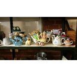 A shelf of collector's teapots