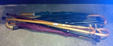 A quantity of walking sticks and umbrella's