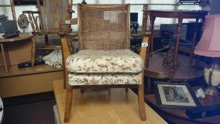 A small arm chair with cane back