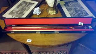 A cased snooker cue