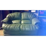 A green leather 2 seater sofa